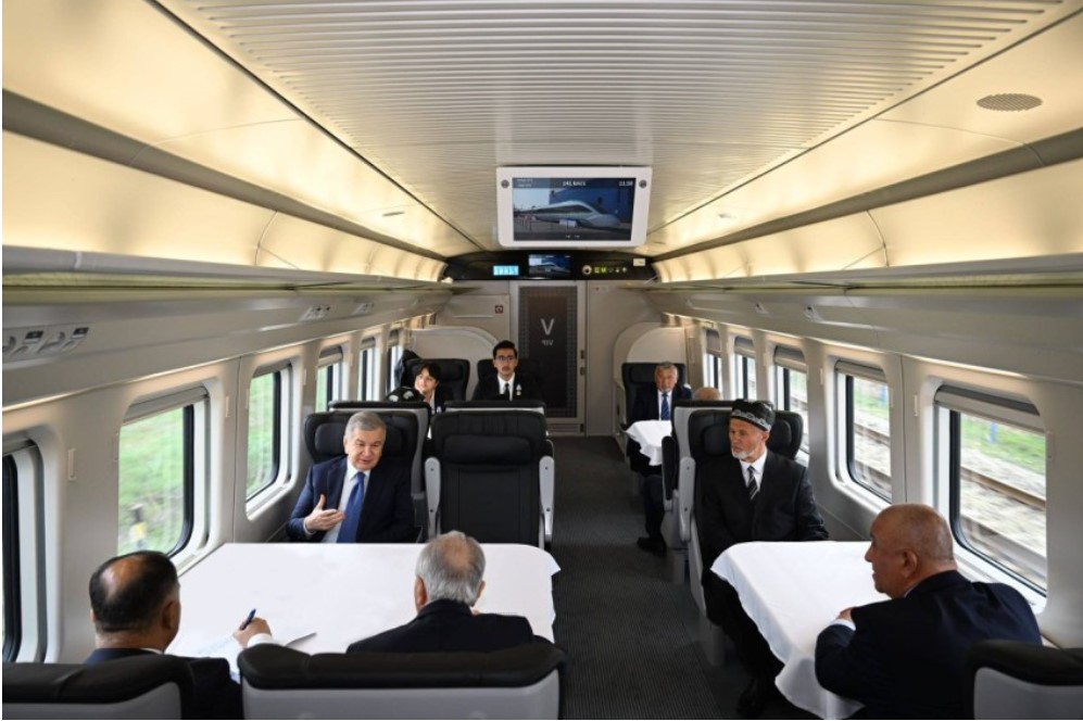 President Shavkat Mirziyoyev took a ride from Samarkand to Narpay on a freshly delivered Hyundai Rotem high-speed train. The white train with tinted windows features blue, green, and red stripes reminiscent of the Uzbekistan flag.